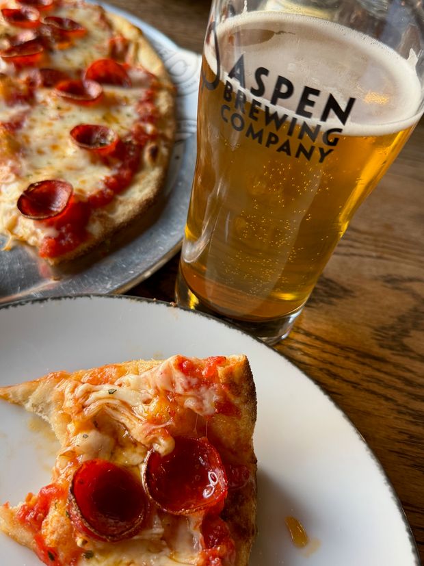 Pepperoni pizza and a glass of Aspen Brewing Company beer