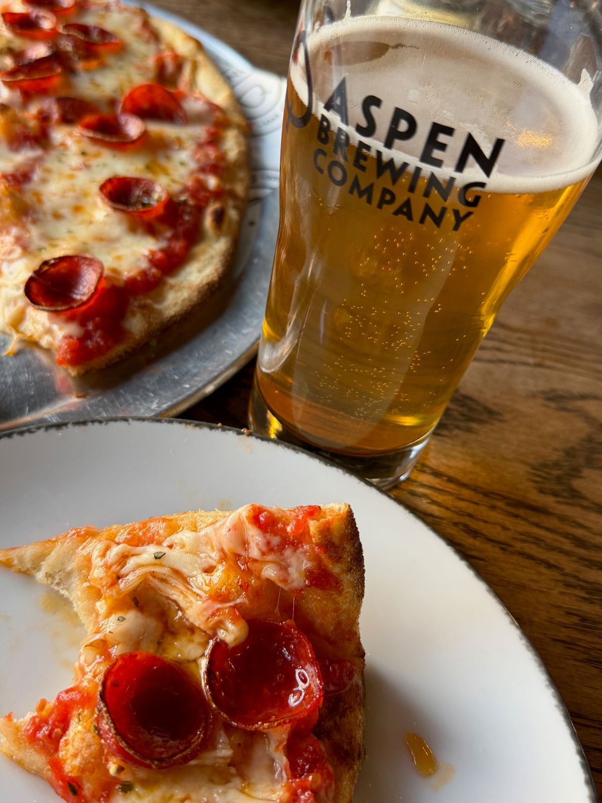 Pepperoni pizza and a glass of Aspen Brewing Company beer